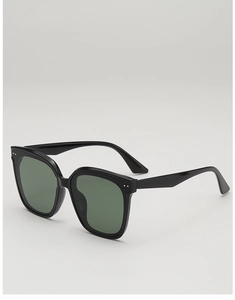 Detail view of stylish square black frames with metal rivets and dark green lenses