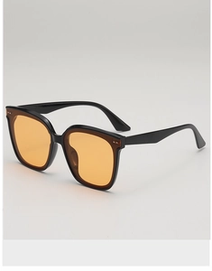 Detail view of square black frames with orange lenses and silver stud rivets