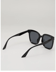 Detail view of the metal hinge and sturdy black square frame of these stylish sunglasses