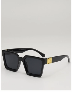 Detail of square sunglasses with black frame and golden metal hinge decorative element