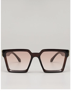 Detail view of square gradient pink lenses and gold metal accents on burgundy frames
