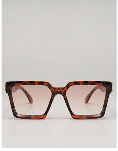 Detailed front view of square tortoiseshell sunglasses with gold metal hinge accents