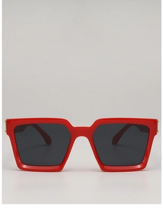 Detailed view of red square sunglasses with dark lenses and gold metal hinge accents