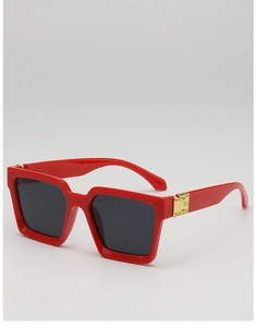Detailed macro view of square red sunglasses with stylish golden metal decorative buckles