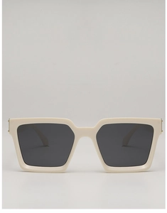 Detailed close-up of cream square sunglasses frame with golden metal hinge accents