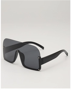 Detail of semi-rimless oversized sunglasses with silver metal studs and wide temples