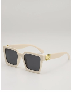 Detail of square milky white frame sunglasses with golden metal hinge hardware