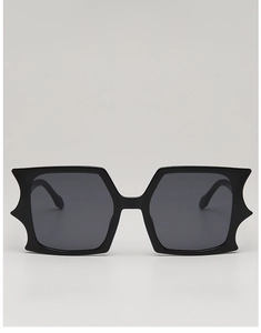 Detail of black avant-garde butterfly sunglasses with wide rectangular wing frames