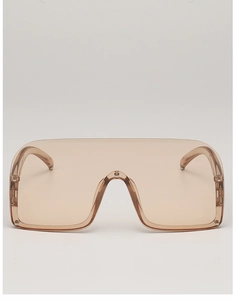 Detail of shield sunglasses with tawny semi-transparent lenses and silver rivet accents