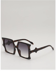 Detail of tortoiseshell frame butterfly sunglasses with grey gradient lenses and star wings