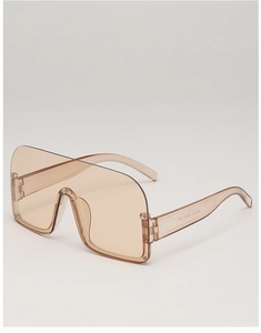 Detailed macro view of semi-rimless shield sunglasses with brown integrated lens and logo