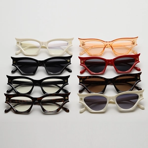 Flat lay of cat-eye sunglasses collection with metal V-shape accent in various colors