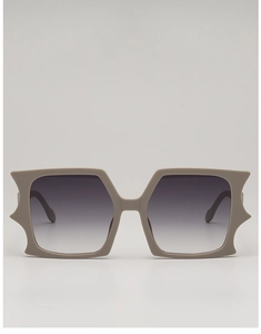 Detail of oversized butterfly sunglasses featuring grey gradient lenses and geometric frame
