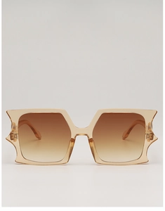 Detail of oversized champagne resin frame and brown gradient lenses on these sunglasses