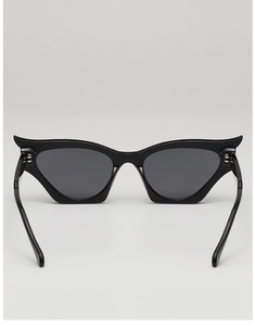 Detail of sleek black cat-eye sunglasses with unique pointed wing-shaped frame design