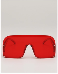 Close-up of semi-rimless red sunglasses with integrated lens and silver metal rivets