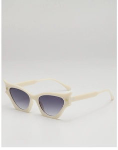 Close-up of cat-eye sunglasses with cream frame, gradient lenses and gold logo detail