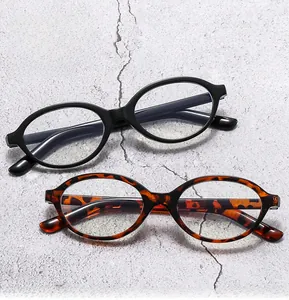 Detail view of oval eyeglass frames in classic black and vintage leopard textures
