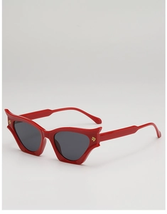 Detailed side view of red cat eye sunglasses with golden metal hinge ornaments