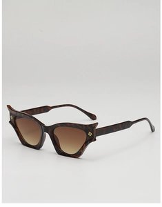 Detailed view of tortoiseshell cat-eye sunglasses with brown gradient lenses and gold accents