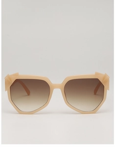 Close-up of cream beige irregular sunglasses frame with 3D angular cut edges and brown lens