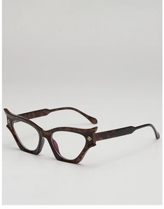 Detail of tortoise shell cat-eye frames featuring golden logo accent on the side temple