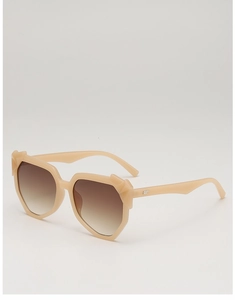 Detail of beige irregular oversized sunglasses with brown gradient lenses and metal accents