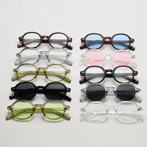 Flat lay of oval sunglasses in assorted frame colors including tortoiseshell and transparent