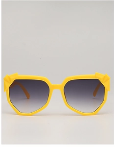 Detail of yellow geometric textured sunglasses frame with grey gradient lenses