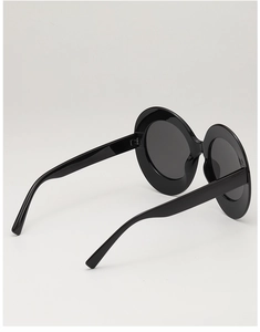 Side view detail of large vintage oval black sunglasses frame with sturdy hinge design