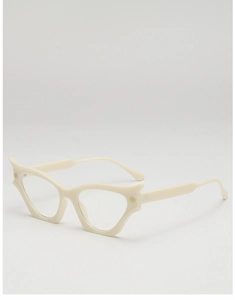 Detail of cream cat-eye sunglasses frame with gold logo and polished finish