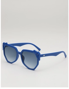 Detail of bright blue geometric irregular sunglasses with grey gradient lenses and silver logo