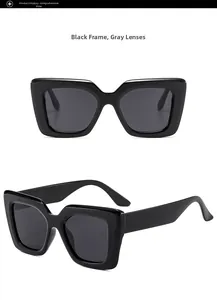 Detail view of stylish black oversized square cat-eye sunglasses with gray lenses