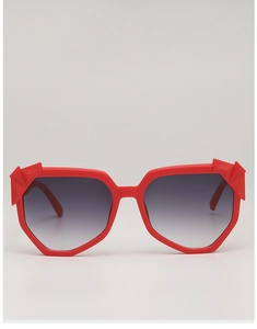 Close-up of red chunky irregular sunglasses frame with 3D geometric faceted corners