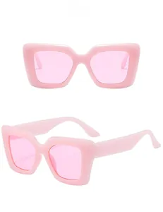 Close-up of pink oversized square sunglasses with translucent frames and matching lenses