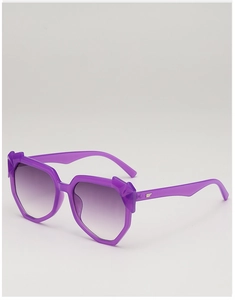 Close-up of translucent purple geometric sunglasses with wing-shaped metal temple decor