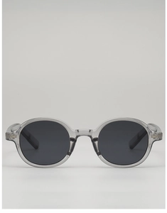 Detail view of retro oval sunglasses with grey translucent frames and metal rivets