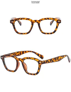 Detail view of square tortoiseshell sunglasses with brown leopard pattern and clear lenses