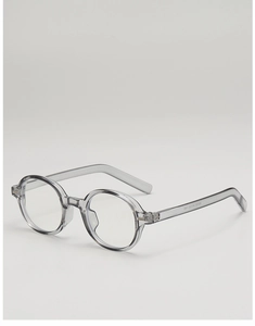 Detail view of oval semi-transparent grey sunglasses showing inner temple metal reinforcement