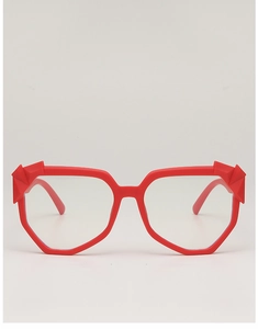 Detail of red oversized eyeglass frame featuring 3D geometric relief on the temple edges
