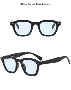 Detail of square black frame sunglasses with light blue lenses and silver rivets