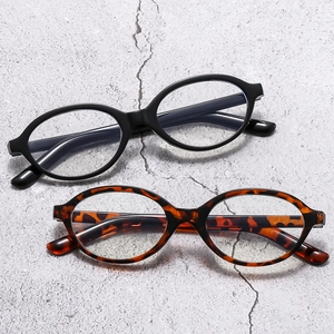Retro oval full-rim eyeglasses in black and tortoiseshell finish on textured background