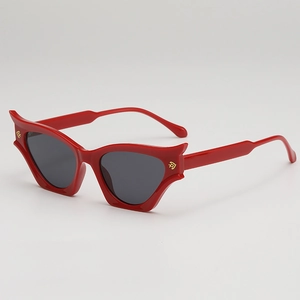 Fashionable red cat eye sunglasses with dark lenses and gold metal logo accents