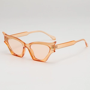 Fashionable cat eye sunglasses with orange transparent frames and flame-inspired wing design
