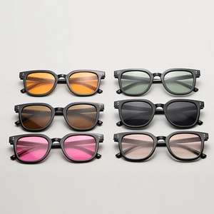 Flat lay of retro square sunglasses set with various colored lenses and silver rivets