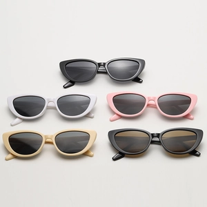 Detailed flat lay of vintage cat eye sunglasses in black, white, pink, and beige frames