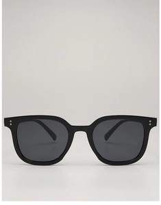 Close-up of square black frame sunglasses with silver rivet details and grey lenses