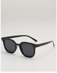 Detail view of square black retro sunglasses with silver rivet accents and grey lenses