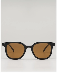 Close-up of square black frame sunglasses featuring brown lenses and metal rivet details