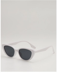 Close-up of vintage white cat-eye sunglasses with dark lenses on a neutral background
